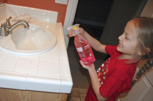 Elfie cleans bathroom counter with Method