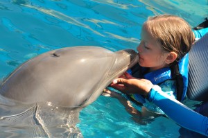 Girl kissing dolphins, Puerto Vallarta, Aquaventuras Park
