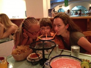 Mom and kids sharing a big virgin strawberry margarita
