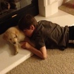 boy snuggling puppy