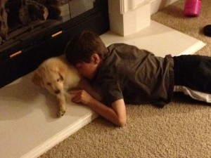 boy snuggling puppy