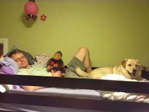 dad and dog lounging on upper bunk bed