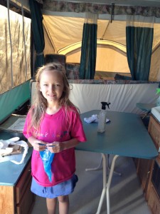little girl cleaning tent trailer