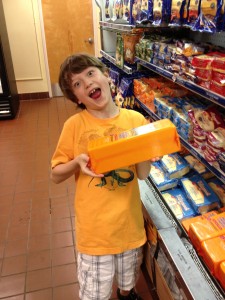 Boy with huge block of Tillamook cheese at factory