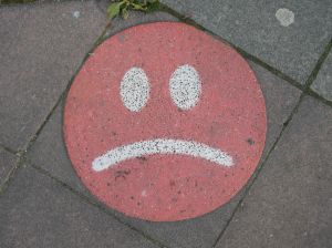 unhappy face on sidewalk