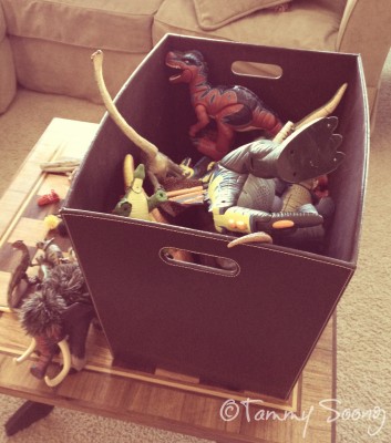 Box of toy dinosaurs
